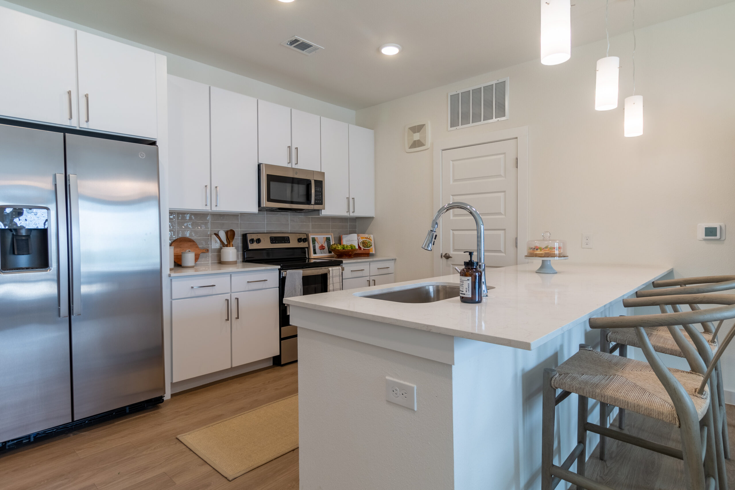 Bright kitchen with ample cabinet storage at Potranco Commons